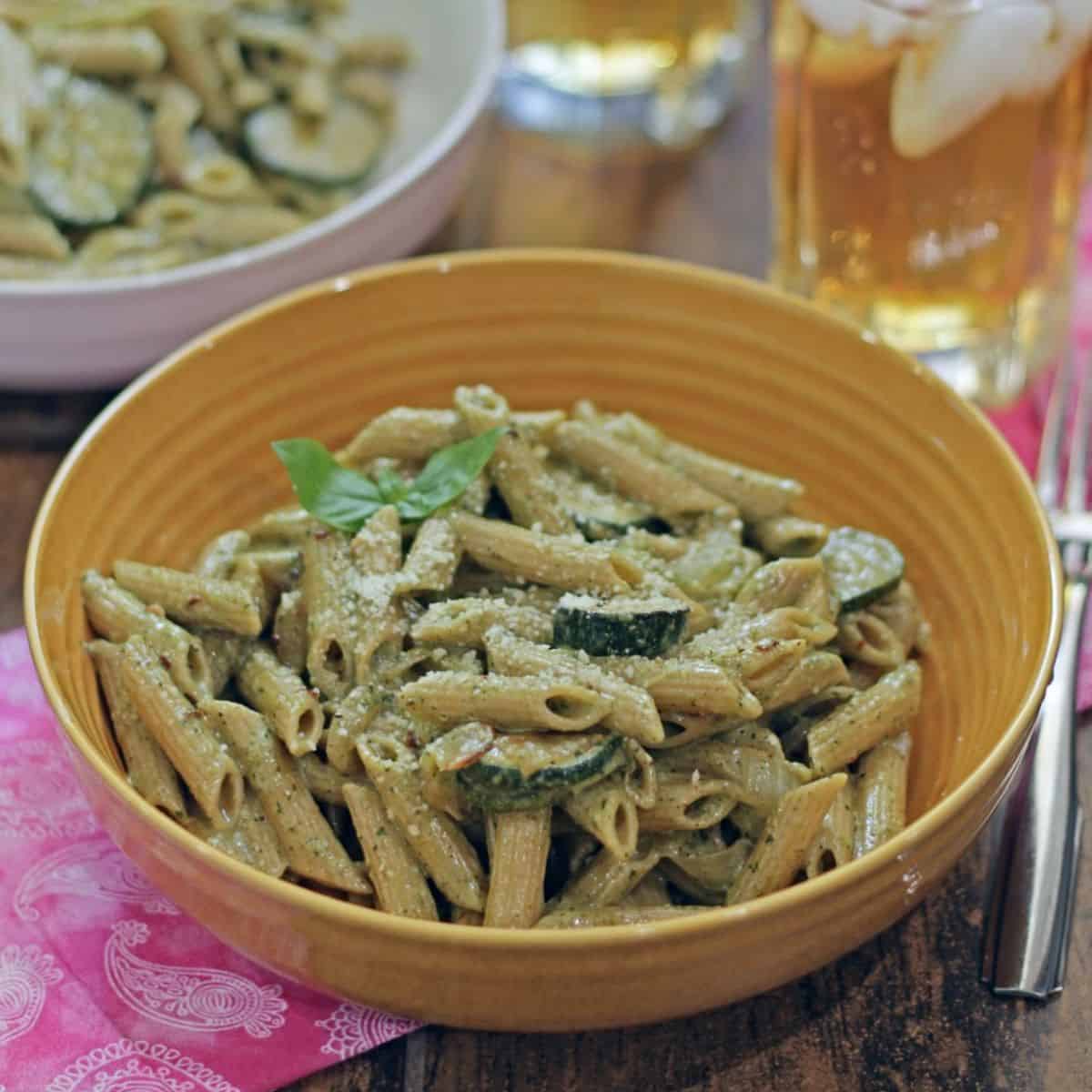 Zucchini pesto pasta in a yellow bowl