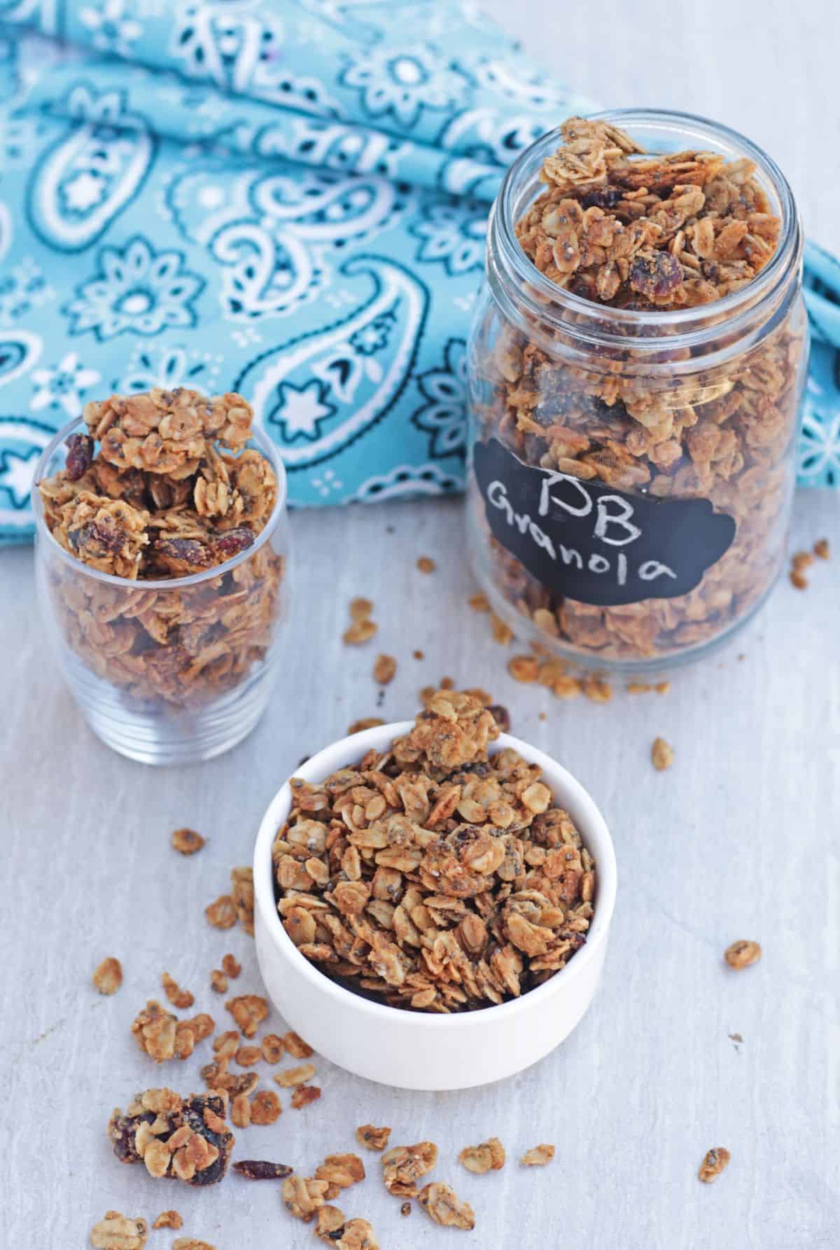 granola in a jar and bowls and blue napkin in the background