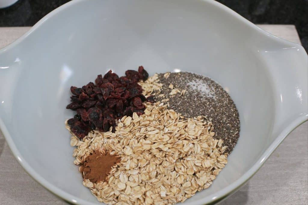 oats, cranberry, chia seeds and cinnamon in a bowl