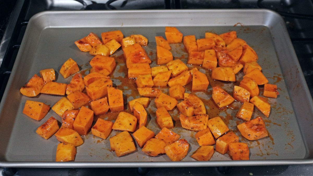 butternut squash pieces on a baking sheet