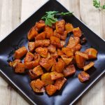 roasted butternut squash in a black plate