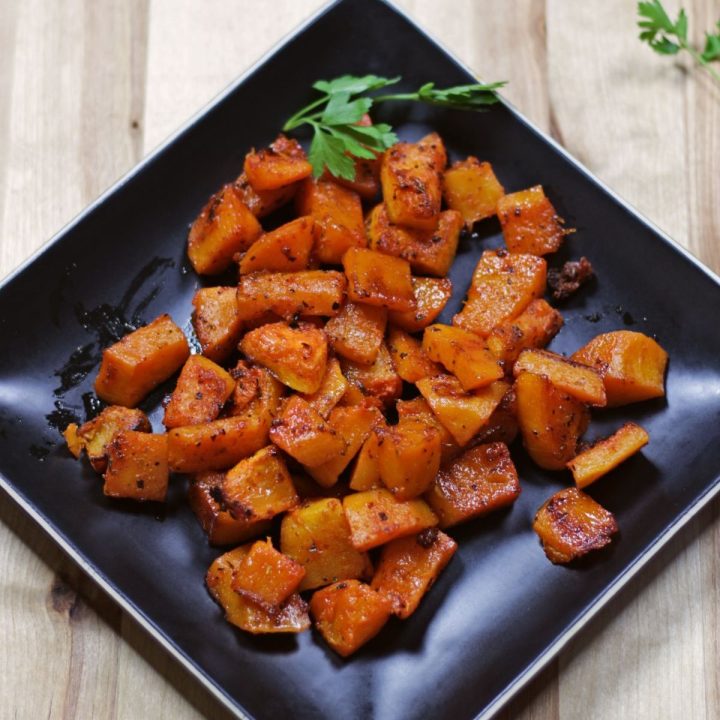 roasted butternut squash in a black plate