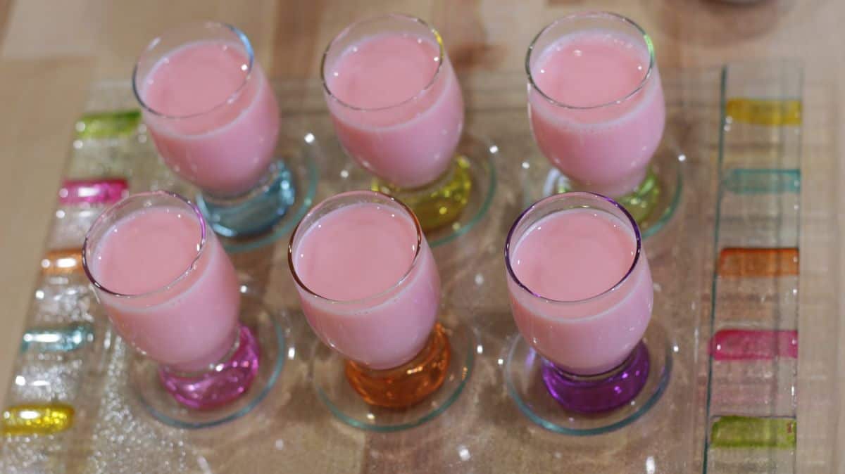 rose milk pudding poured in individual glass cups