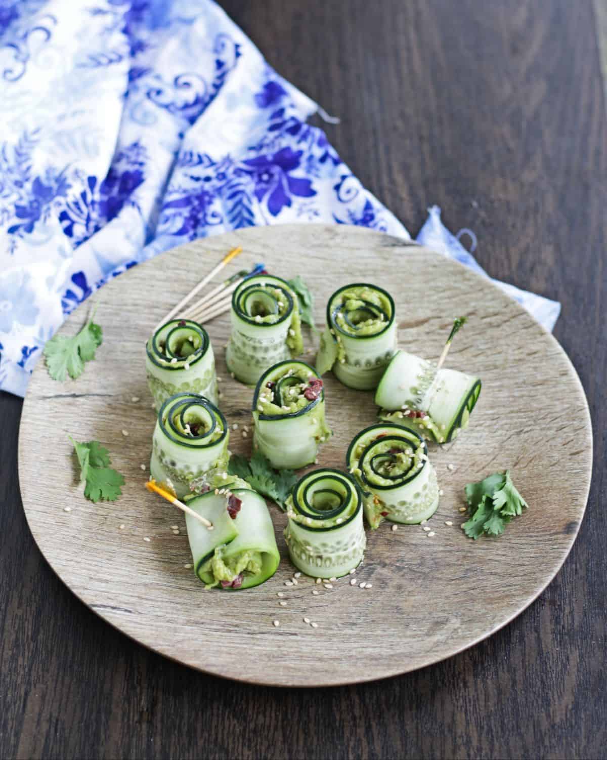 thin slices of cucumber rolled with sesame seeds garnish and tooth picks 