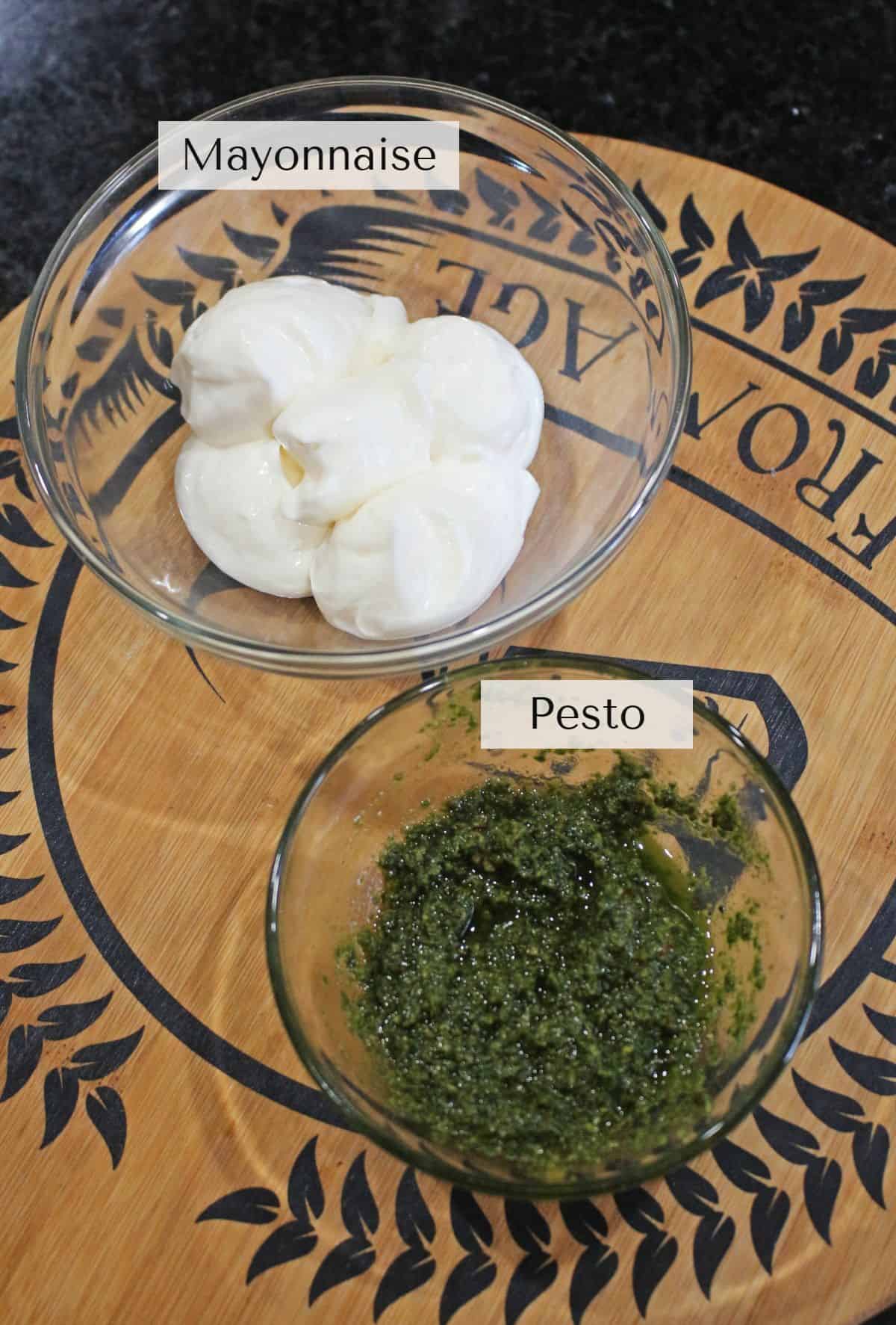pesto and mayo in bowls labeled.