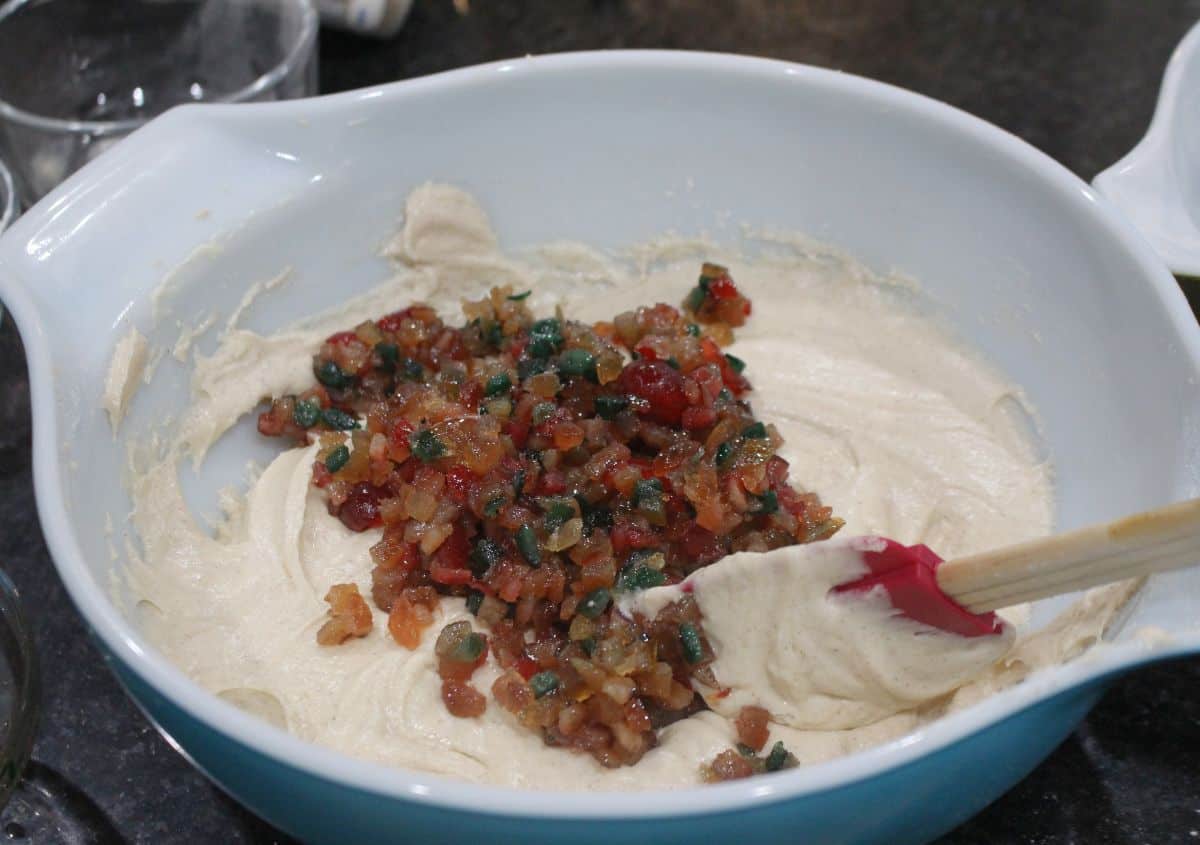 adding fruitcake mix to muffin batter.